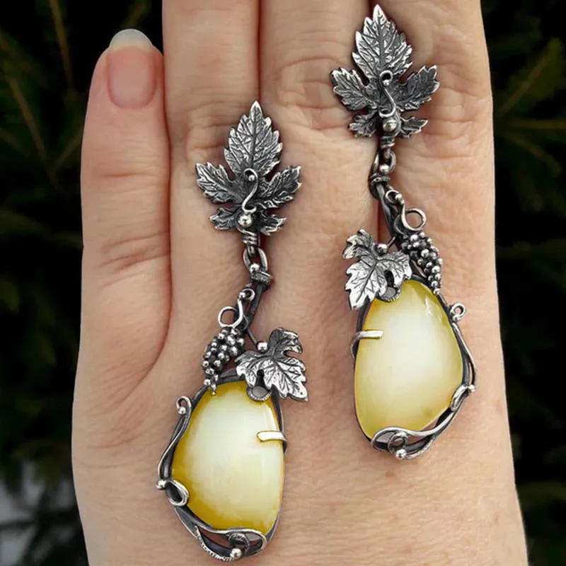 Wholesale Antique Silver Metal Vine Leaf Hand-inlaid White Teardrop-shaped Cat's Eye Earrings